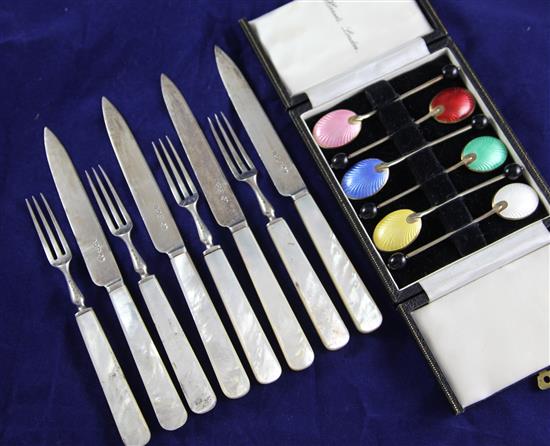 A set of six George V silver and coloured enamel coffee spoons four pairs silver mother of pearl handled dessert eaters.